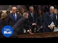 George W. Bush gives Michelle Obama candy at father's funeral