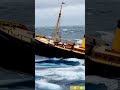 unbelievable small ship conquers enormous waves.