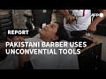 Pakistan barber offers hair-raising cuts with cleavers and blowtorches | AFP