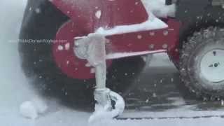 Snow blower clearing walkway of snow in Winter archival stock footage