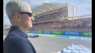 Tim Cook waving chequered flag at USGP 🏁 😐