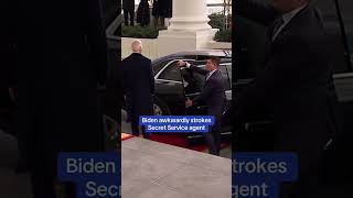 Biden awkwardly strokes Secret Service agent