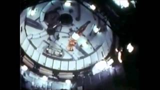 NASA astronauts performing gymnastics on board of the Skylab