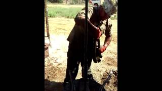 Wrenching rods floor hand. Kevin Flores