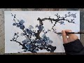 Artist painting Plum blossom with a traditional Chinese brush