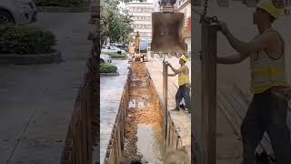 Use excavator installing steel sheet pile underground of Road construction work