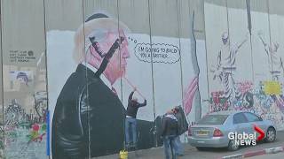 Palestinians paint over mural depicting Donald Trump