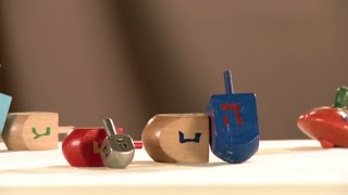 Why do we play dreidel on Hanukkah