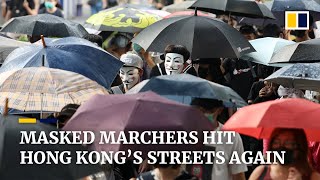 Thousands of masked marchers take to Hong Kong’s streets protesting the government’s emergency law