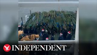 Michigan high school students load 1,200 Christmas trees onto ship for Chicago