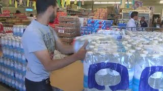 E. coli contamination drives up water bottle sales, closes restaurants