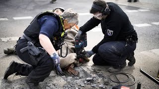 Police use drill to free activist's hand during climate protest in Germany