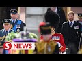 William and Harry walk together behind a loved one's coffin, again