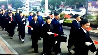 Taoist Priests Are Waving National Flags And Singing Red Songs In A Parade In Ruzhou.