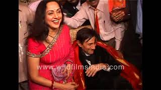 Hema Malini sits next to Dev Anand, Dev Anand holds her hand...