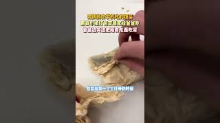 男孩将在学校吃的饭菜，用餐巾纸打包带回家给爸爸吃，爸爸边笑边把所有东西吃完