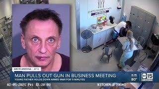 Father disarms man after gun is pulled during meeting