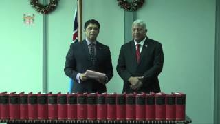 Fijian Attorney-General Hon, Aiyaz Sayed-Khaiyum hands over new Fiji Law Books to Prime Minister.