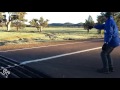 man helps out kangaroo stuck in grate