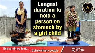 Longest duration to hold a person on stomach by a girl child