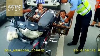 Footage: Elderly man carries children in fruit baskets on motorcycle