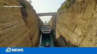 Cruise ship makes tight squeeze through canal