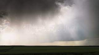 Stock Video - Sun rays shining through dark storm clouds