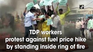 TDP workers protest against fuel price hike by standing inside ring of fire