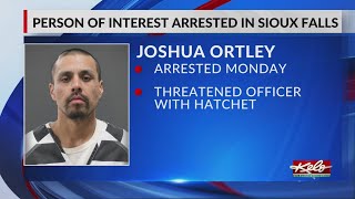 Wanted man accused of threatening officer with hatchet