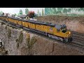 triple headed athearn genesis ho union pacific dda40x on large club layout.