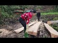 helping my sister cut wood to make house pillars. the two sisters went to cut wood