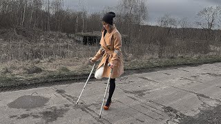 Girl leg amputee pretender, walk on crutches with one leg in a high heel