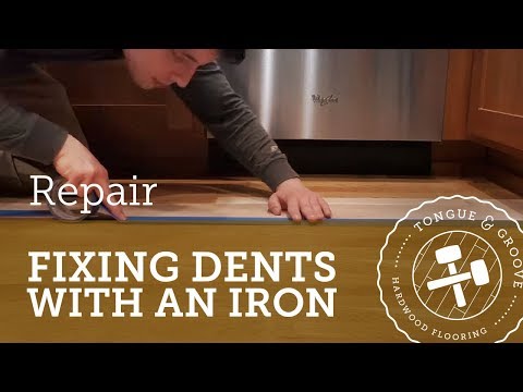 Repairing dents in a hardwood floor with an iron Repairing dents in a hardwood floor with an iron