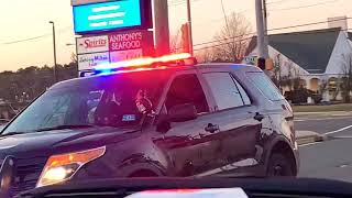 Lacey Township Police unit guiding traffic while construction workers are working on a pot hole