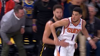 Klay Thompson scores through Devin Booker his 9 3-pointer in the first half vs Suns