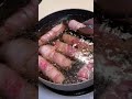 Bacon-wrapped hotdog with hot sauce