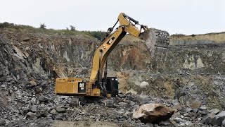 Caterpillar 390F excavator crushes huge stones with a heavy steel ball