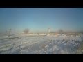 long southbound up train with cp grain hoppers in the snow on the spine line