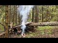 Building a shelter for survival in a wild forest. Escaping from rain and wind far from civilization.