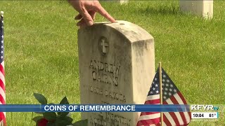 Paying respect to veterans with coins on their graves