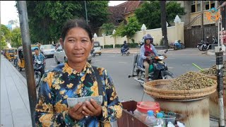 Sister Cho Sopheap, a street boiled periwinkles seller, receives Cambodian-American funds