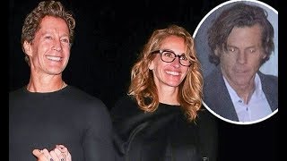 Julia Roberts walks hand-in-hand with a male friend while husband Daniel Moder trails behind at pre-