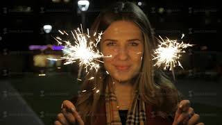 Portrait of beautiful young smiling girl on the background of the winter night Christmas lights