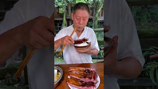 A simple farm meal at noon, with tiger skin green peppers and cured pork ribs