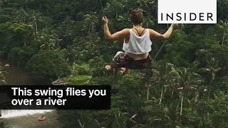 This backyard swing flies out over a beautiful river