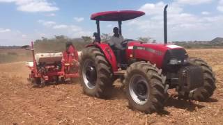 A CASE IH jx75t 4wd pulling a KUHN 18m Lexis sprayer