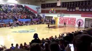 Police officer and student do a trick shot for swine week at EMHS