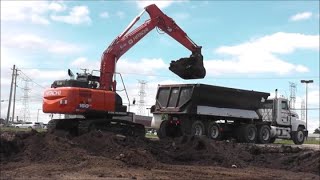 Excavator Loading Topsoil Into Dump Truck Hitachi 160 LC