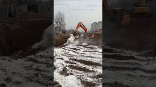 The process of excavator spreading lime powder at the construction site