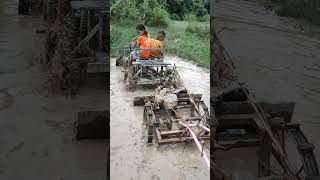 Tractor helps push Aun Kanika recycling truck that is stuck